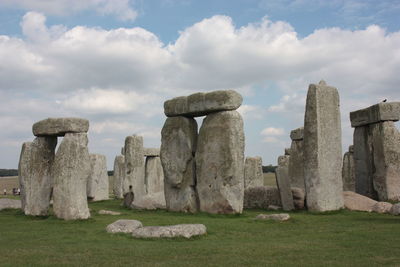 Stone structure in park against cloudy sky