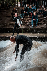 Full length of man with dog in water