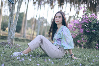 Young woman sitting on field