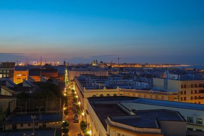 High angle view of illuminated buildings against sky at dusk