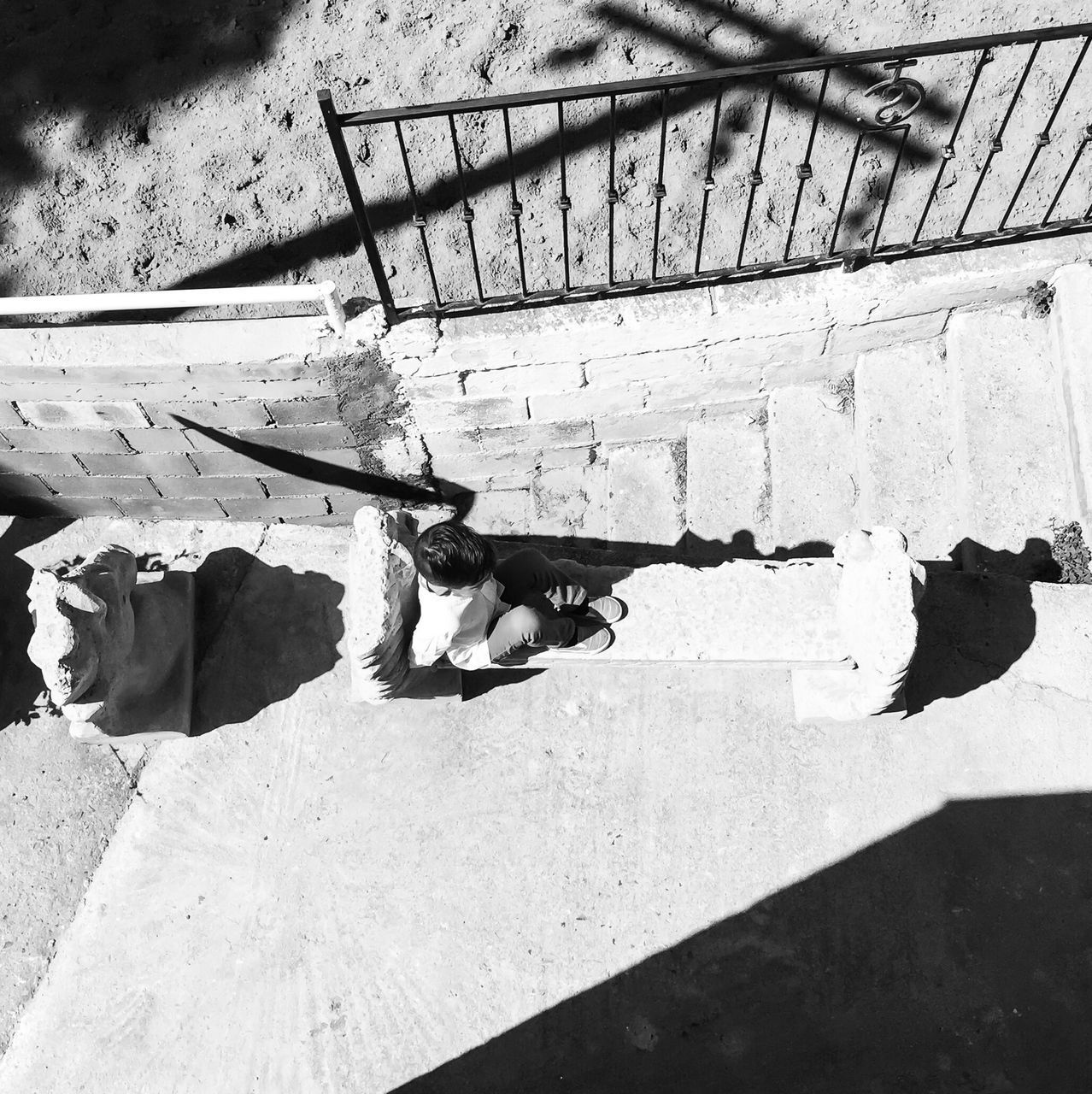 high angle view, shadow, sunlight, sand, beach, day, relaxation, steps, water, outdoors, no people, nature, railing, in a row, pattern, built structure, paving stone, shore, absence, bench