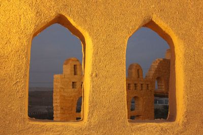 Buildings seen through arch window