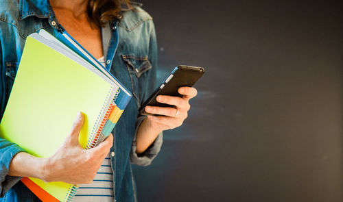 Midsection of woman using mobile phone