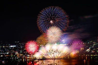 Low angle view of firework display at night