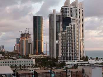 Modern buildings in city against sky