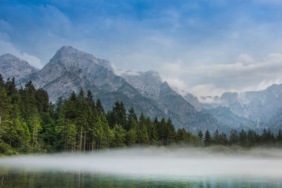 Scenic view of lake and mountains against sky