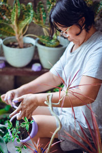 Midsection of woman holding potted plant