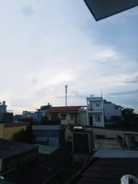 Buildings in city against sky during sunset