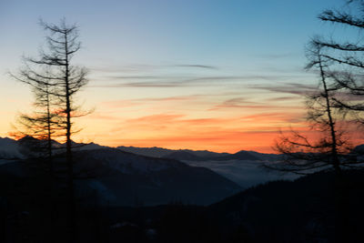 Scenic view of silhouette mountains against sky during sunset
