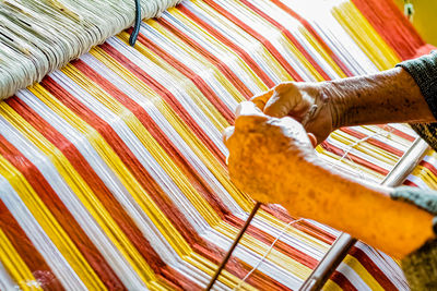 High angle view of woman working at loom