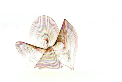 Close-up of multi colored umbrella against white background