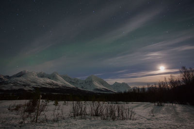 Scenic view of snow covered landscape against sky at dusk