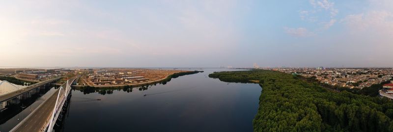 High angle view of river and cityscape against sky