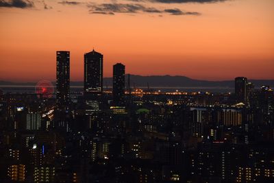Illuminated city at sunset