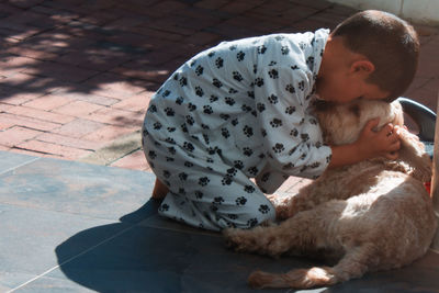 Rear view of boy with dog