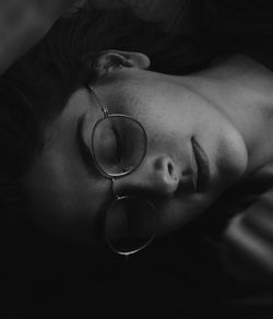 High angle view of woman wearing eyeglasses while sleeping