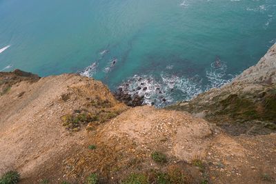 High angle view of rocks by sea