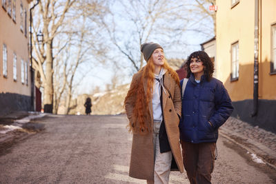 Smiling young women walking in street