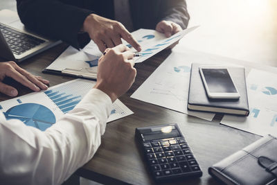 Cropped image of business people working in office