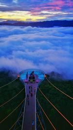 High angle view of airplane flying over landscape against sky