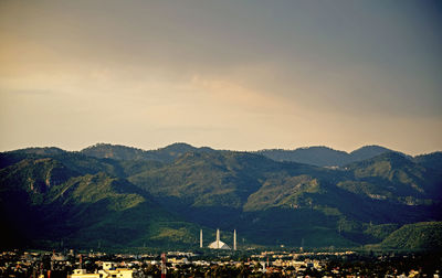 Cityscape with mountain range in background