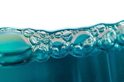 Close-up of water splashing against white background