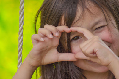 Close-up portrait of girl holding hands