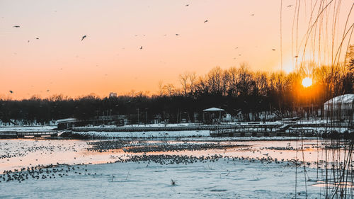 Scenic view of lake against sky during winter