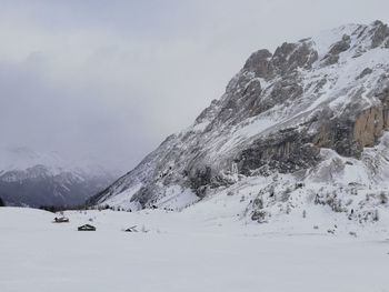 Scenic view of snow covered mountains against sky