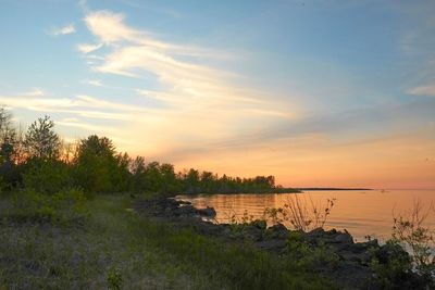 Scenic view of lake against sky during sunset