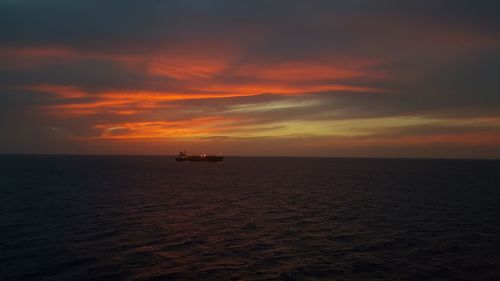 Scenic view of sea against orange sky