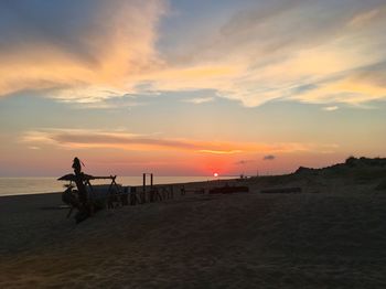 Scenic view of beach against sky during sunset