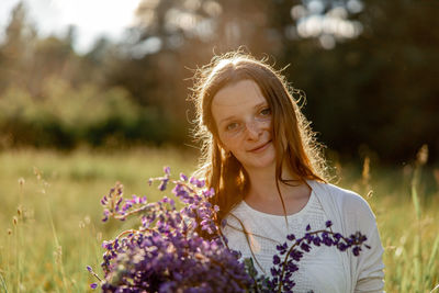 Close up portrait of young beautiful redhead woman with freckles, wearing white dress