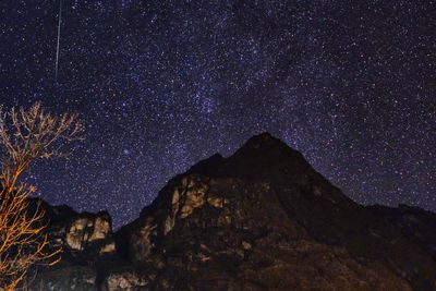 Low angle view of mountain against sky at night