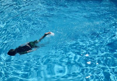 High angle view of boy swimming in pool