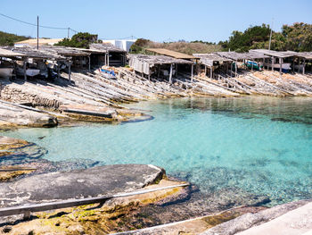 Scenic view of swimming pool by lake against sky