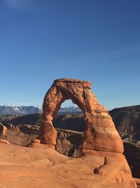 Rock formation against clear blue sky