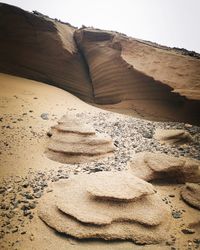 Sand dunes in desert against sky