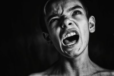 Close-up of teenage boy with mouth open