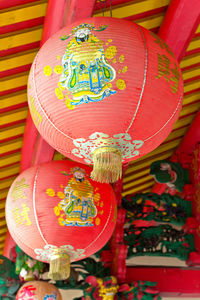 Close-up of multi colored decoration hanging in traditional clothing