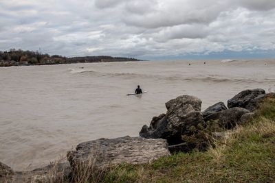 Surfers heading out on a lake 