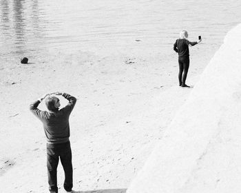 Full length of man photographing on beach