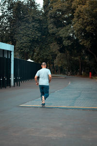 Rear view of man walking on street