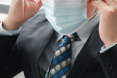 Midsection of businessman wearing mask