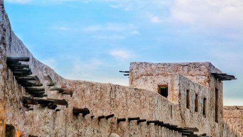 Low angle view of old ruin building against sky