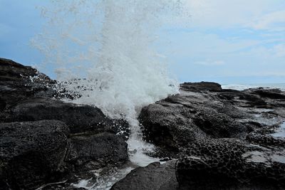 Close-up of splashing water against sky