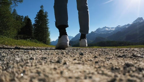 Low section of man standing on street