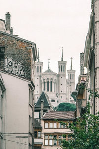 Low angle view of buildings in city against clear sky