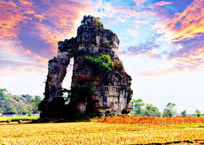 Scenic view of rocks on field against sky