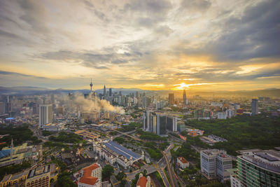 High angle view of cityscape against cloudy sky